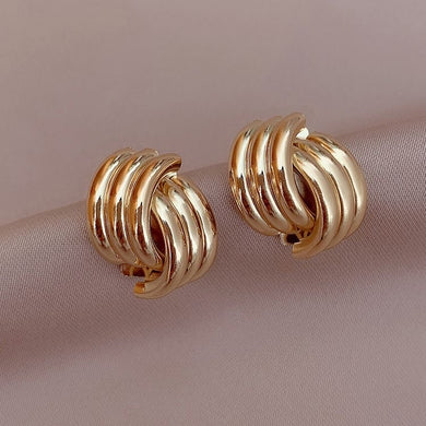 6. Wrapped gold coloured stud earrings