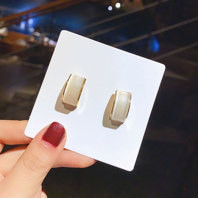 10. White rectangle earrings with gold border